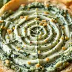 spiderweb spinach dip in a bread bowl - featured image